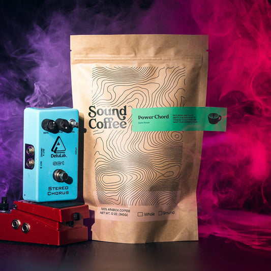 Sound Coffee Power Chord dark roast coffee bag with guitar pedals and colorful smoke background