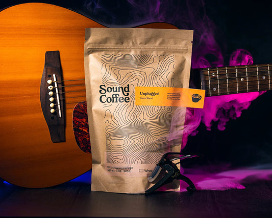 Sound Coffee Unplugged decaf blend bag beside acoustic guitar, Bridgeport CT coffee shop