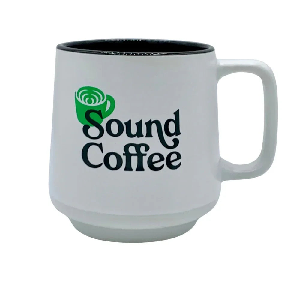 White ceramic Sound Coffee mug with green logo, perfect for enjoying fresh roasted coffee.