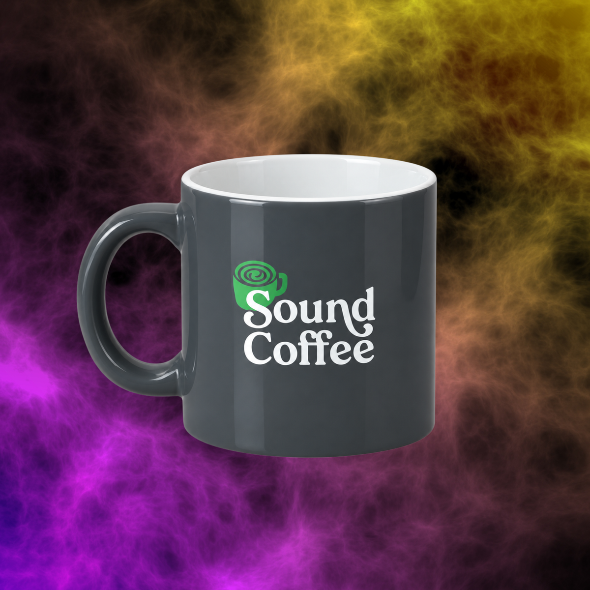 A dark gray ceramic coffee mug with a white interior and handle, featuring a green coffee cup icon and the words 'Sound Coffee' printed on the front. The mug is centered against a dramatic, colorful smoky background with purple, yellow, and black tones.