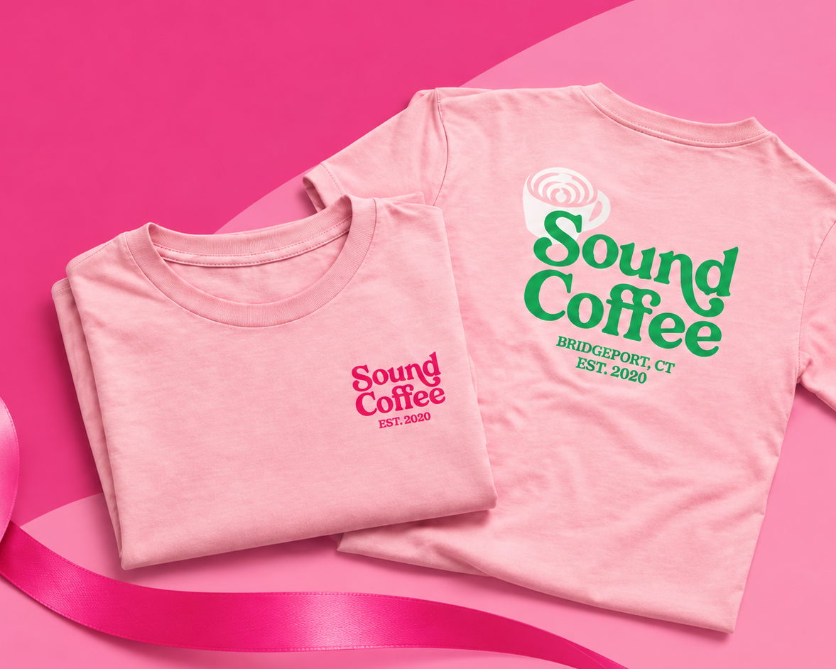 Two folded light pink t-shirts with 'Sound Coffee' graphics in green and pink, arranged on a bright pink background with a pink ribbon.