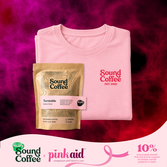 Sound Coffee pink logo on a tee, and a pack of Sound Coffee Turntable blend. There is a banner at the bottom that says Sound Coffee x Pink Aid and the 10% of the proceeds benefit the Pink Aid in support of breast cancer patients