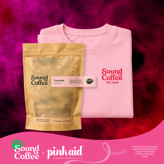 A folded light pink t-shirt with a red 'Sound Coffee EST. 2020' logo is displayed next to a gold coffee bag labeled 'Sound Coffee Turfable' on a dark pink and purple textured background, with a pink 'Sound Coffee x pinkaid' banner at the bottom.