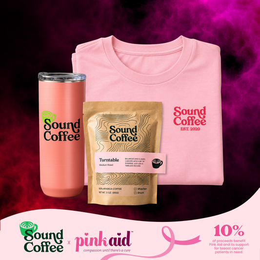 Sound Coffee pink logo on a tee, and a pack of Sound Coffee Turntable blend, and a cup on the side. There is a banner at the bottom that says Sound Coffee x Pink Aid and the 10% of the proceeds benefit the Pink Aid in support of breast cancer patients