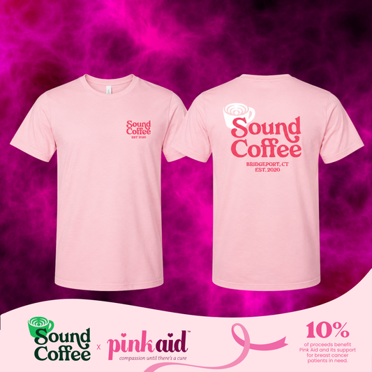 Sound Coffee pink logo on a tee and a banner at the bottom that says Sound Coffee x Pink Aid and the 10% of the proceeds benefit the Pink Aid in support of breast cancer patients